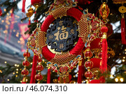 Festive decorations on a fir tree and Chinese red paper lanterns are seen during Lunar New Year celebration in Moscow, Russia. Редакционное фото, фотограф Николай Винокуров / Фотобанк Лори