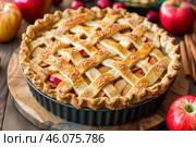 Delicious homemade apple pie baking with latticed crust and fresh red apples. Стоковое AI-изображение, AI-художник Иван Рябоконь / Фотобанк Лори