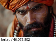 Indian sadhu wearing orange turban and showing religious symbols. Стоковое AI-изображение, AI-художник Иван Рябоконь / Фотобанк Лори