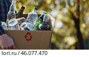Cropped unrecognized person carrying crate of empty plastic bottles. Recycling plastic concept. Hands with Recycle Bin. Littering of environment. Problem of global plastics pollution of the Earth. Стоковое AI-видео, аниматор Марина Демидюк / Фотобанк Лори