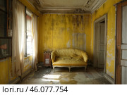 Abandoned yellow room with elegant sofa and curtains showing decay and neglect. Стоковое AI-изображение, AI-художник Иван Рябоконь / Фотобанк Лори
