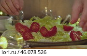 The process of preparing Caesar salad, which includes ripe cherry tomatoes and iceberg lettuce. Стоковое видео, видеограф Strunov David / Фотобанк Лори