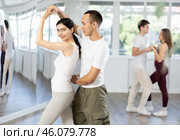 Girl paired up with young man, they train to perform slow waltz dance, rehearse performance. Стоковое фото, фотограф Яков Филимонов / Фотобанк Лори