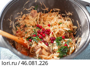 Stewed fresh cabbage with lingonberries cooked in a cauldron, light delicious vegetarian lunch. Стоковое фото, фотограф Коханова Наталья / Фотобанк Лори