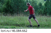 Exploring Nature a Hiker with backpack Strolling Through a Beautiful Field Beneath Vast Blue Sky. Tourist man traverses a scenic field, clear blue sky. Adventure and exploration concept. One person. Стоковое видео, видеограф Марина Демидюк / Фотобанк Лори
