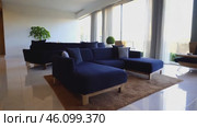 Living room with a blue couch and a white rug. Стоковое AI-видео, аниматор Sergey Grishin / Фотобанк Лори