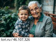A happy family, a child and a grandmother hug on the street in the park, happy and contented. A grandmother who hugs her grandson, showing love. Стоковое AI-изображение, AI-художник Photojuli / Фотобанк Лори