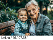 A happy family, a child and a grandmother hug on the street in the park, happy and contented. A grandmother who hugs her grandson, showing love. Стоковое AI-изображение, AI-художник Photojuli / Фотобанк Лори