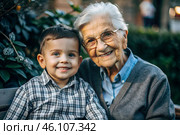 A happy family, a child and a grandmother hug on the street in the park, happy and contented. A grandmother who hugs her grandson, showing love. Стоковое AI-изображение, AI-художник Photojuli / Фотобанк Лори