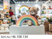 Beautiful colorful showcase of a children's store with a rainbow and a teddy bear. The concept of shopping and shopping for children's goods. Стоковое AI-изображение, AI-художник Photojuli / Фотобанк Лори
