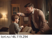 Father scolding his son in a warmly lit living room during an evening conversation about behavior. Стоковое AI-изображение, AI-художник Sergey Grishin / Фотобанк Лори