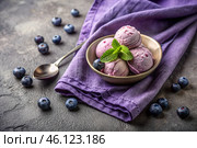 Sweet dessert. The love of ice cream. Blueberry ice cream balls and fresh blueberries. Banner, advertisement. Стоковое AI-изображение, AI-художник Photojuli / Фотобанк Лори