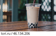 Chilled Bubble Tea on Wooden Table. Стоковое видео, видеограф Данил Руденко / Фотобанк Лори
