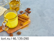 Golden milk in a transparent glass cup. Curcumin, anise, cinnamon. covid-19 protection. The concept of health and longevity. Стоковое фото, фотограф Кутина Татьяна / Фотобанк Лори