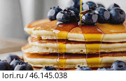 Homemade Pancakes stack with blueberries and honey on a modern ceramic plate. Classic blueberry pancake stack filled with syrup among gray concrete wall background. Sweet breakfast with berry, fruit. Стоковое AI-видео, аниматор Марина Демидюк / Фотобанк Лори