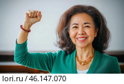 Middle aged hispanic woman with raised fist of empowerment, strength and women solidarity, International Womens Day concept. Стоковое AI-изображение, AI-художник Анастасия Золотницкая / Фотобанк Лори