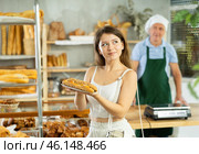 Young woman buyer with bocadillo in bakery. Стоковое фото, фотограф Яков Филимонов / Фотобанк Лори