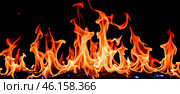 Bright orange and yellow flames with blue accents on black background, intense fire burning, dynamic fiery shapes, hot blazing inferno, vivid firelight. Стоковое фото, фотограф Павел Муравьев / Фотобанк Лори