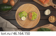 Making healthy gluten-free buckwheat crispbread sandwiches with smoked salmon, avocado and egg, stop motion animation. Preparing dietary vegetarian eating. Стоковое видео, видеограф Мария Зубарева / Фотобанк Лори
