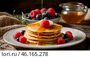 Delicious pancakes with honey, blueberries, raspberries and . The concept of the Russian holiday Maslenitsa. Стоковое AI-изображение, AI-художник Photojuli / Фотобанк Лори