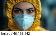 A young woman in a yellow protective suit and a medical mask. Her expressive blue eyes look straight ahead, emphasizing determination and concentration. The yellow suit creates a contrast with the dark, blurred background, and the protective mask gives the image associations with working in hazardous conditions. The atmosphere of the frame conveys a sense of preparation for an emergency, epidemiological control, scientific work or the elimination of the consequences of pollution. Стоковое AI-изображение, AI-художник Анна Кривицкая / Фотобанк Лори