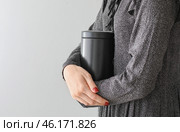 Woman with mortuary urn on light background. Стоковое фото, фотограф Pixel_shot / Фотобанк Лори