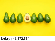 Whole avocados and one half on color background. Concept of uniqueness. Стоковое фото, фотограф Pixel_shot / Фотобанк Лори