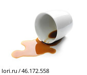 Overturned cup and spilled coffee on white background. Стоковое фото, фотограф Pixel_shot / Фотобанк Лори