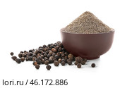 Bowl with black pepper powder on white background. Стоковое фото, фотограф Pixel_shot / Фотобанк Лори
