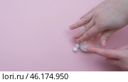 Taba paw pink and white colorful anti-stress toys squirt on baby's hand. Стоковое видео, видеограф Терехова Марина / Фотобанк Лори