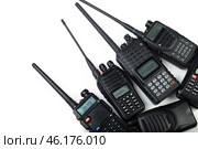Collection of handheld walkie-talkies arranged on a white background showcasing various models and features. Стоковое фото, фотограф Сергей Толмачёв / Фотобанк Лори