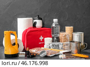 Necessities for emergency bag on dark table. Стоковое фото, фотограф Pixel_shot / Фотобанк Лори