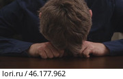 Exhausted, tired businessman puts his head in his hands and falls asleep from overwork. concept sleep deprivation and professional burnout in workplace in office. close-up. front view. Стоковое видео, видеограф ЛУНИНА ВЕРОНИКА / Фотобанк Лори