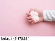 Taba paw pink and white colorful anti-stress toys squirt on baby's hand. Стоковое фото, фотограф Терехова Марина / Фотобанк Лори