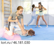 Pair self defense training - two teenage girls doing power grabs. Стоковое фото, фотограф Яков Филимонов / Фотобанк Лори