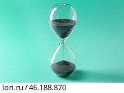 Hourglass on color background. Time management concept. Стоковое фото, фотограф Pixel_shot / Фотобанк Лори