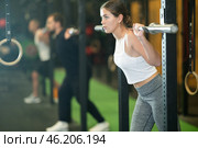 Determined young girl working out with gym rod during crossfit workout. Стоковое фото, фотограф Яков Филимонов / Фотобанк Лори