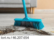 Sweeping of rubbish with plastic broom, closeup. Стоковое фото, фотограф Pixel_shot / Фотобанк Лори