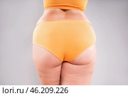 Overweight thigh, woman with fat hips, legs and buttocks, obesity female body with cellulite on gray background. Стоковое фото, фотограф Станислав Тарко / Фотобанк Лори
