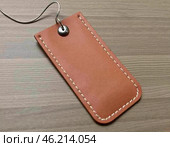 This leather hanging tag sample features a minimalist design with a sturdy loop and a slot for cards. Ideal for customizing luggage or gifts with a touch of elegance. Generative AI. Стоковое AI-изображение, AI-художник Юлия Петровская / Фотобанк Лори