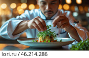 Chef carefully plating a gourmet dish with fresh microgreens in a bustling restaurant kitchen during golden hour. Стоковое AI-изображение, AI-художник Сергей Толмачёв / Фотобанк Лори