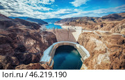 Majestic view of a massive concrete dam in a desert canyon. Стоковое AI-изображение, AI-художник Екатерина Усенко / Фотобанк Лори