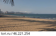 Public beach in Nha Trang, Vietnam. Beautiful view of the embankment, mountains, beach and South China Sea. Tourists and locals relax and swim. Handheld shooting in slow motion. Overview. Стоковое видео, видеограф Наталья Любина / Фотобанк Лори