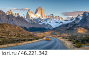 Yellow car driving on a scenic road towards mount fitz roy at sunset in patagonia, argentina. Стоковое AI-изображение, AI-художник Юрий Поздников / Фотобанк Лори
