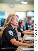 Female police officer working at computer in busy dispatch center. Стоковое AI-изображение, AI-художник Юрий Поздников / Фотобанк Лори