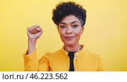 Black mature woman with raised fist of empowerment, strength and women solidarity, International Womens Day, Black History Month concept. Стоковое AI-изображение, AI-художник Анастасия Золотницкая / Фотобанк Лори