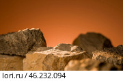 Rocky surface with rough texture, empty stone podium for product placement, natural stone background with warm lighting, showcasing products, earthy tones, rugged rocks, textured stones. Стоковое фото, фотограф Павел Муравьев / Фотобанк Лори