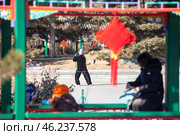 Женщина делает упражнения в парке. The Palace park in the Forbidden City located in Beijing, China (2024 год). Стоковое фото, фотограф Кекяляйнен Андрей / Фотобанк Лори