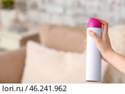 Woman spraying air freshener in room. Стоковое фото, фотограф Pixel_shot / Фотобанк Лори