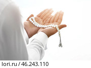 Young Muslim man praying indoors. Стоковое фото, фотограф Pixel_shot / Фотобанк Лори